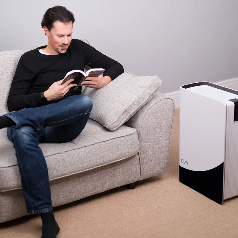EVA Alto infinity Air purifier with man on couch